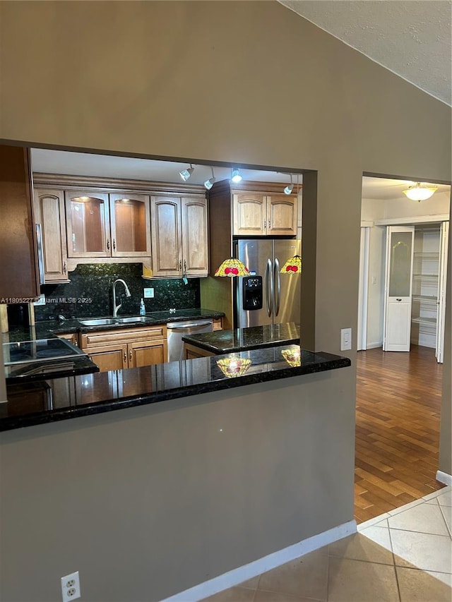 8631 Bridle Path Ct, Davie, FL 33328 - kitchen featuring stainless steel appliances, a sink, decorative backsplash, tile patterned flooring, and dark stone countertops