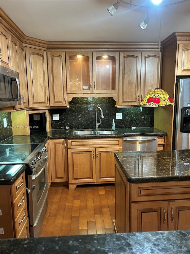 8631 Bridle Path Ct, Davie, FL 33328 - kitchen with appliances with stainless steel finishes, a sink, decorative backsplash, and brown cabinetry