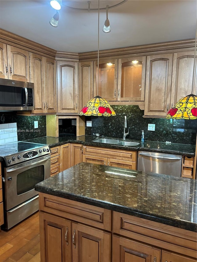 8631 Bridle Path Ct, Davie, FL 33328 - kitchen featuring appliances with stainless steel finishes, a sink, tasteful backsplash, and dark stone countertops