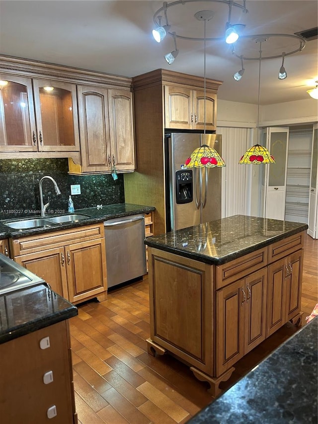8631 Bridle Path Ct, Davie, FL 33328 - kitchen with appliances with stainless steel finishes, a sink, wood-type flooring, and dark stone counters