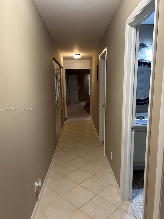 8631 Bridle Path Ct, Davie, FL 33328 - corridor featuring light tile patterned floors and baseboards