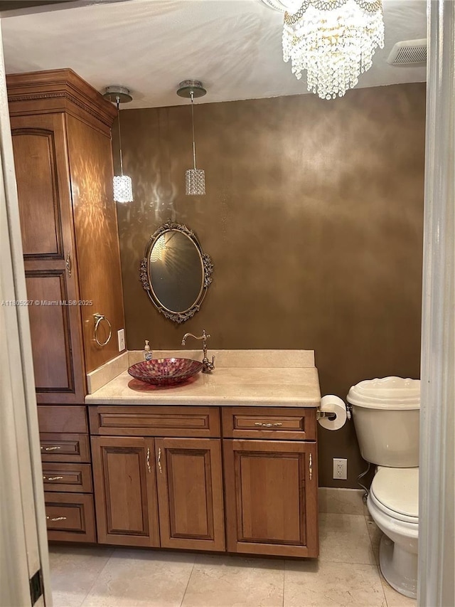 8631 Bridle Path Ct, Davie, FL 33328 - half bath featuring tile patterned flooring, toilet, vanity, and a chandelier