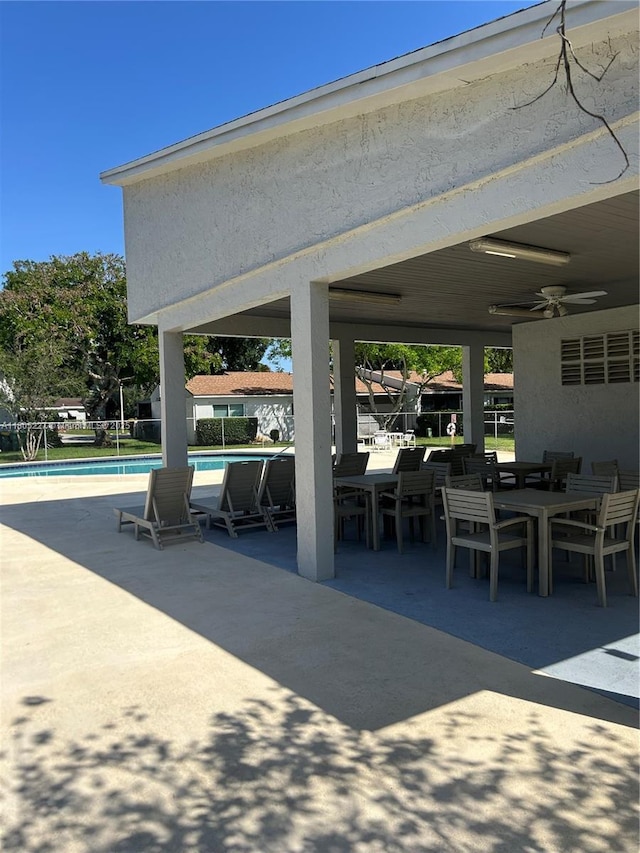 8631 Bridle Path Ct, Davie, FL 33328 - view of patio / terrace featuring outdoor dining area, a community pool, and ceiling fan
