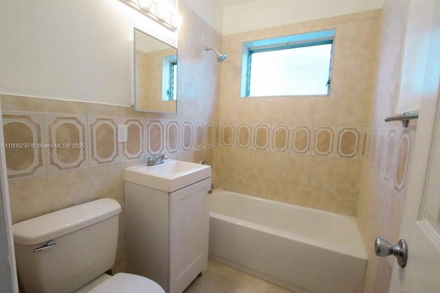 bathroom with toilet, tile walls, shower / tub combination, vanity, and tile patterned floors