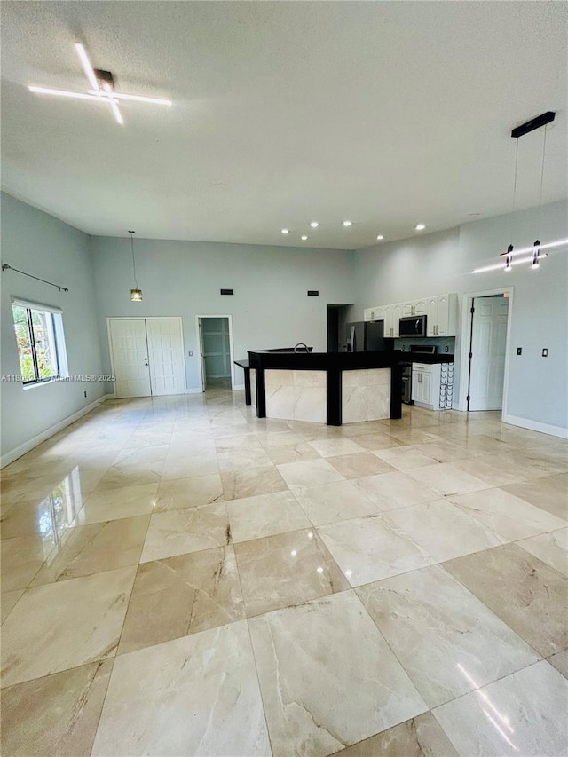 3480 Torremolinos Ave Unit A-33, Doral, FL 33178 - unfurnished living room featuring baseboards and recessed lighting