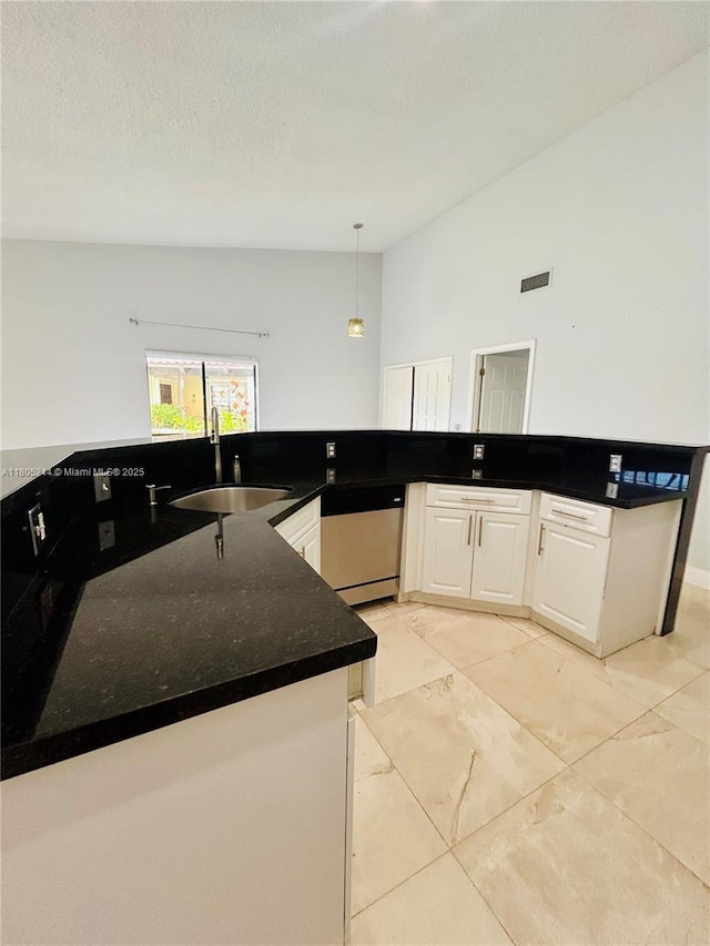 3480 Torremolinos Ave Unit A-33, Doral, FL 33178 - kitchen with a sink, dishwasher, white cabinets, pendant lighting, and dark stone counters
