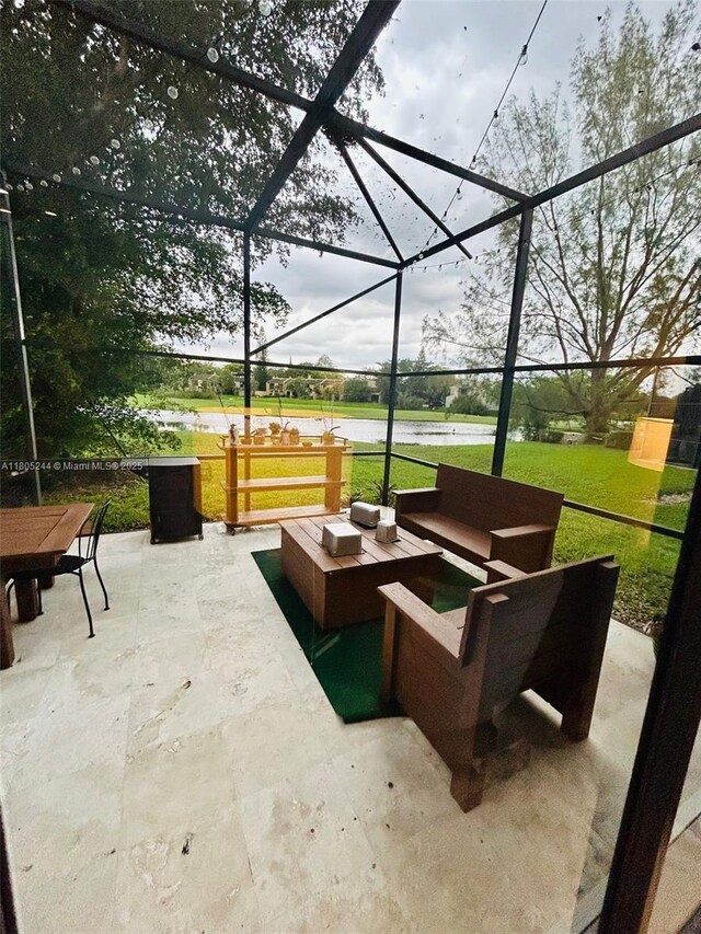 3480 Torremolinos Ave Unit A-33, Doral, FL 33178 - view of patio / terrace featuring outdoor lounge area, glass enclosure, and a water view