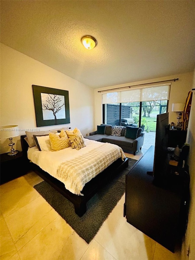 3480 Torremolinos Ave Unit A-33, Doral, FL 33178 - bedroom with access to outside, vaulted ceiling, a textured ceiling, and tile patterned flooring
