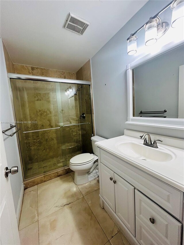 3480 Torremolinos Ave Unit A-33, Doral, FL 33178 - full bath featuring a shower stall, tile patterned floors, vanity, and toilet