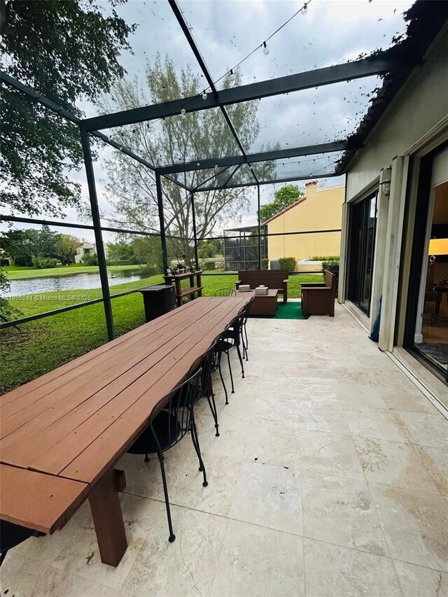 3480 Torremolinos Ave Unit A-33, Doral, FL 33178 - view of patio / terrace featuring outdoor dining area, a water view, a lanai, and outdoor lounge area