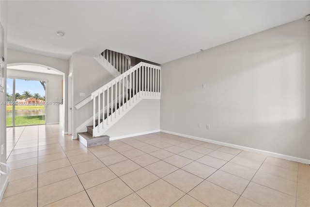 1458 SE 24th Ct Unit 353, Homestead, FL 33035 - foyer with light tile patterned floors, arched walkways, baseboards, and stairway