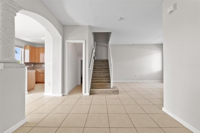1458 SE 24th Ct Unit 353, Homestead, FL 33035 - stairway with arched walkways, tile patterned flooring, and baseboards