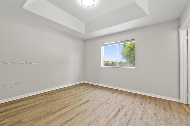 1458 SE 24th Ct Unit 353, Homestead, FL 33035 - spare room featuring a raised ceiling, light wood-type flooring, and baseboards