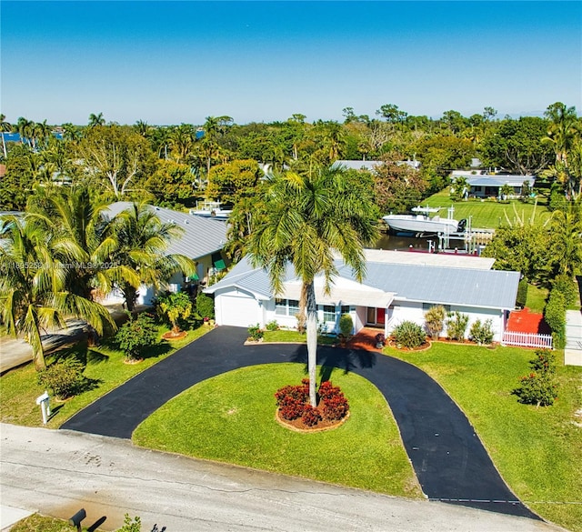 view of front of house with driveway, a garage, and a front lawn