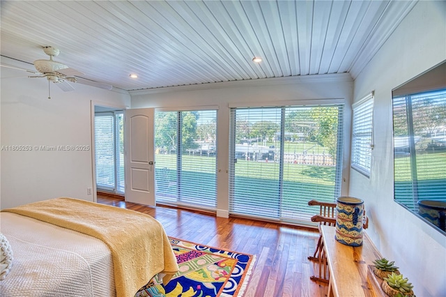 bedroom with access to outside, crown molding, multiple windows, wood finished floors, and recessed lighting