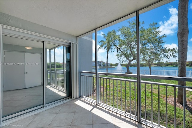 unfurnished sunroom with a water view