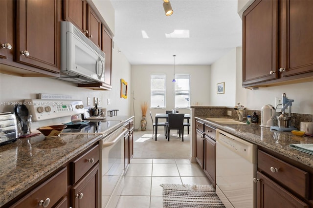 9021 SW 94th St Unit 306, Miami, FL 33176 - kitchen with white appliances, a sink, dark stone countertops, and light tile patterned flooring