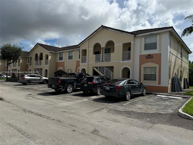 2731 SE 17th Ave Unit 207, Homestead, FL 33035 - view of building exterior with uncovered parking and stairway