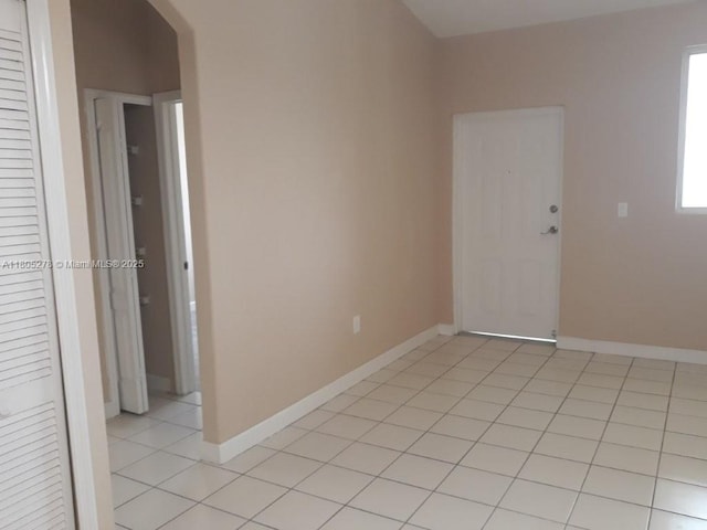 2731 SE 17th Ave Unit 207, Homestead, FL 33035 - empty room featuring arched walkways, light tile patterned flooring, and baseboards