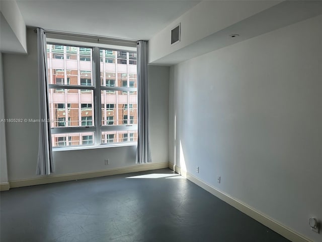 111 E Flagler Unit 702, Miami, FL 33131 - unfurnished room featuring baseboards and concrete floors