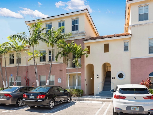 10022 NW 7th St Unit 206, Miami, FL 33172 - view of front of house featuring stucco siding, uncovered parking, and a tile roof