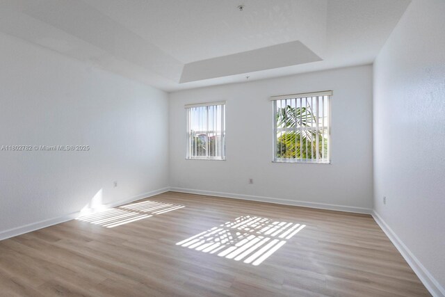 10022 NW 7th St Unit 206, Miami, FL 33172 - empty room with light wood finished floors, baseboards, and a raised ceiling