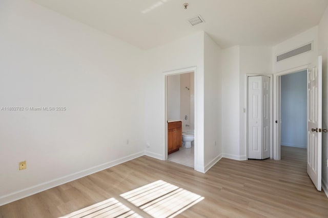 10022 NW 7th St Unit 206, Miami, FL 33172 - unfurnished bedroom with light wood-style flooring, baseboards, and connected bathroom