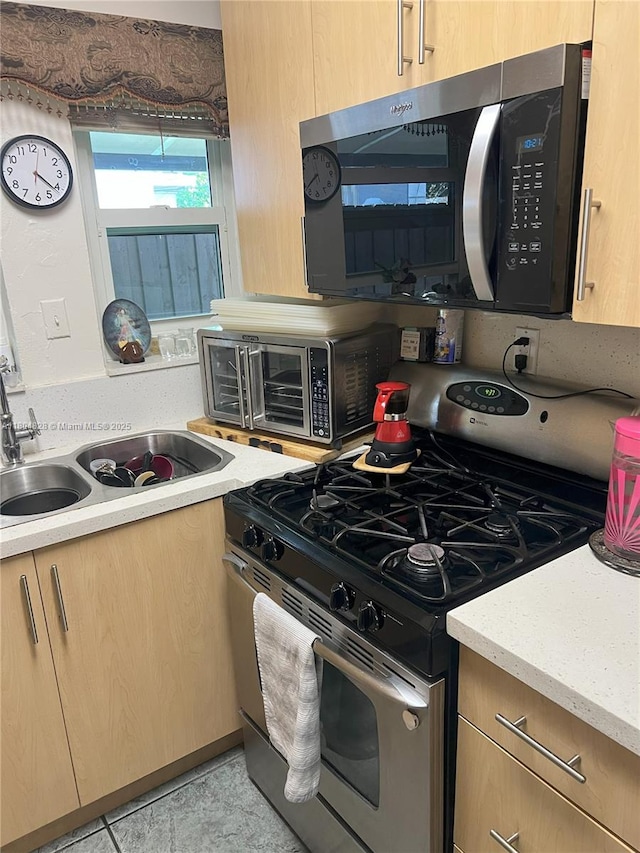 10720 NW 5th Ave, Miami, FL 33168 - kitchen featuring appliances with stainless steel finishes, light brown cabinets, and a sink