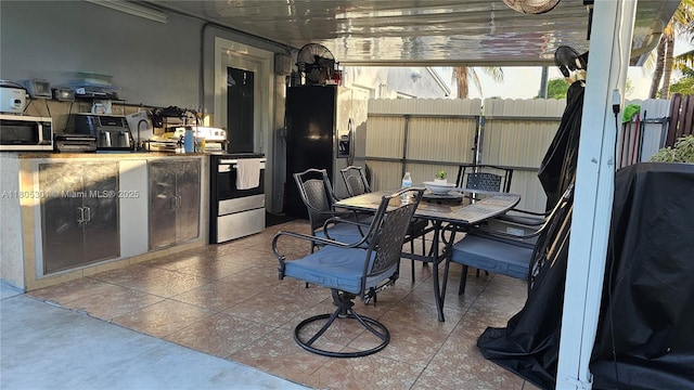 4651 SW 19th St, Fort Lauderdale, FL 33317 - view of patio / terrace with fence, outdoor dining area, an outdoor kitchen, and grilling area