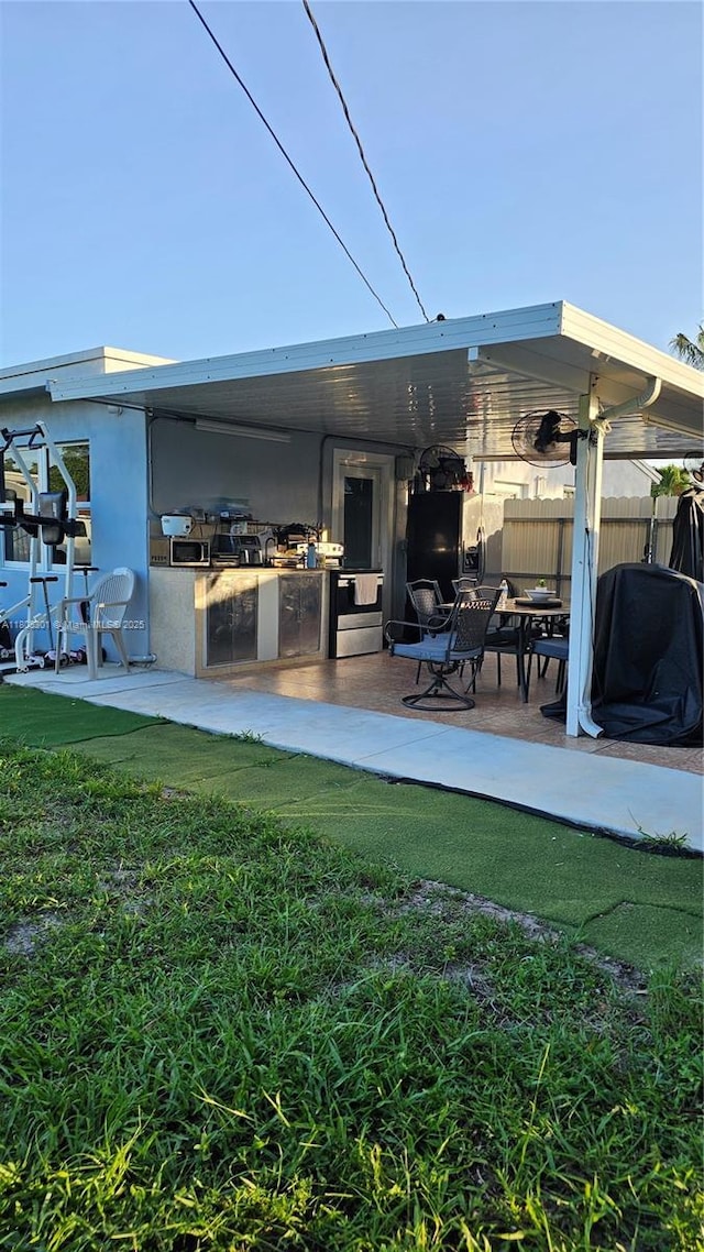 4651 SW 19th St, Fort Lauderdale, FL 33317 - rear view of house featuring fence, a patio area, and exterior bar
