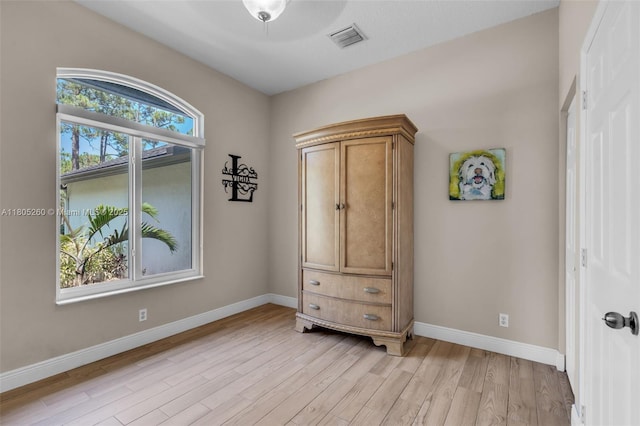 bedroom with light wood-style flooring and baseboards