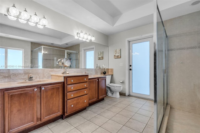 bathroom with tile patterned flooring, a shower stall, vanity, and toilet