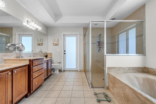 full bathroom with healthy amount of natural light, a stall shower, double vanity, and tile patterned floors