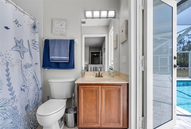 bathroom featuring toilet, vanity, and curtained shower