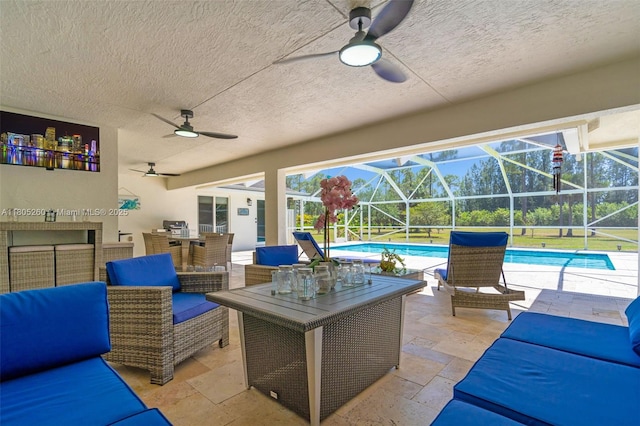 view of patio / terrace featuring a ceiling fan, an outdoor living space, an outdoor pool, and a lanai