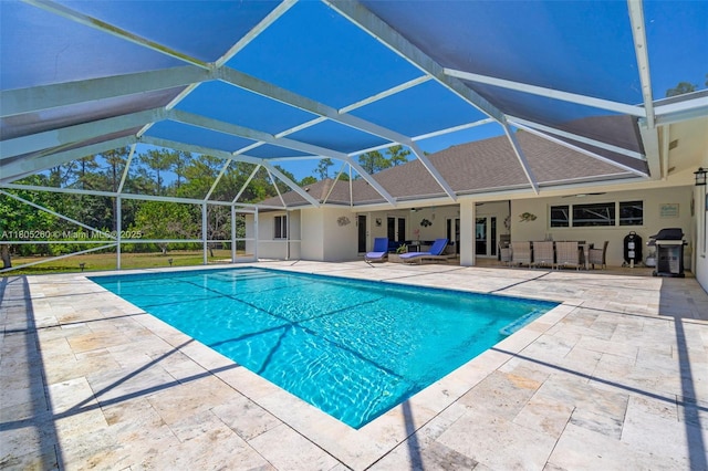 swimming pool with a patio area, area for grilling, and a lanai