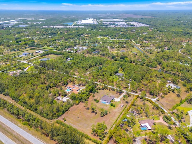 aerial view of property's location with a forest