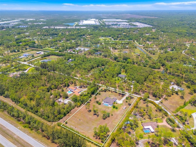 view of property location with property boundaries highlighted and a heavily wooded area