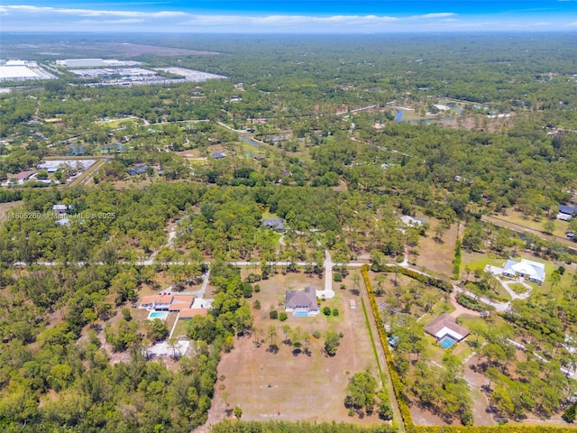 aerial view of property's location with a heavily wooded area