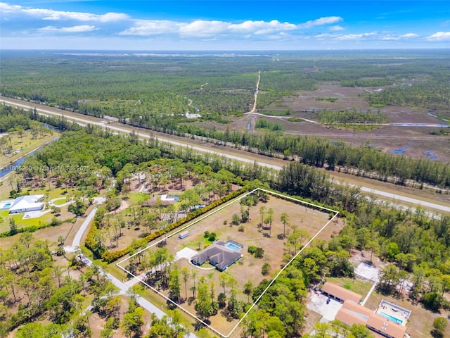 view of property location featuring property parcel outlined and a heavily wooded area