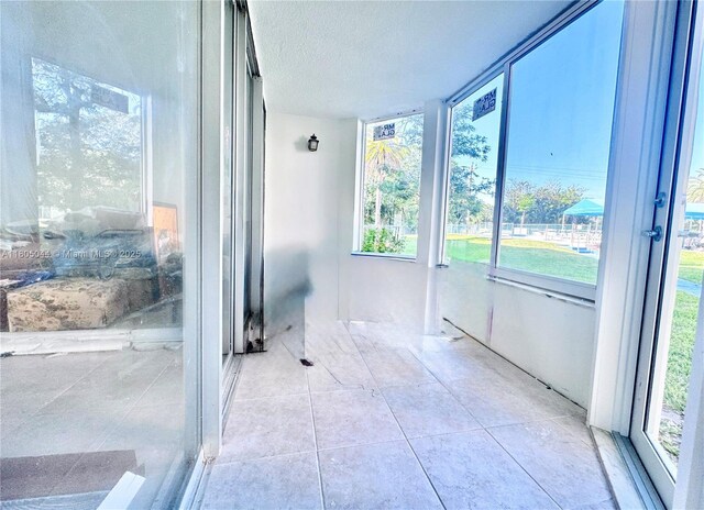 1701 NE 191st St Unit A108, Miami, FL 33179 - sunroom / solarium with plenty of natural light, a textured ceiling, and tile patterned floors