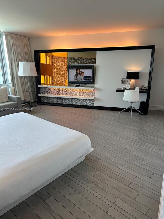 1100 W Ave Unit 1206, Miami Beach, FL 33139 - bedroom with wood finished floors, an office area, and baseboards