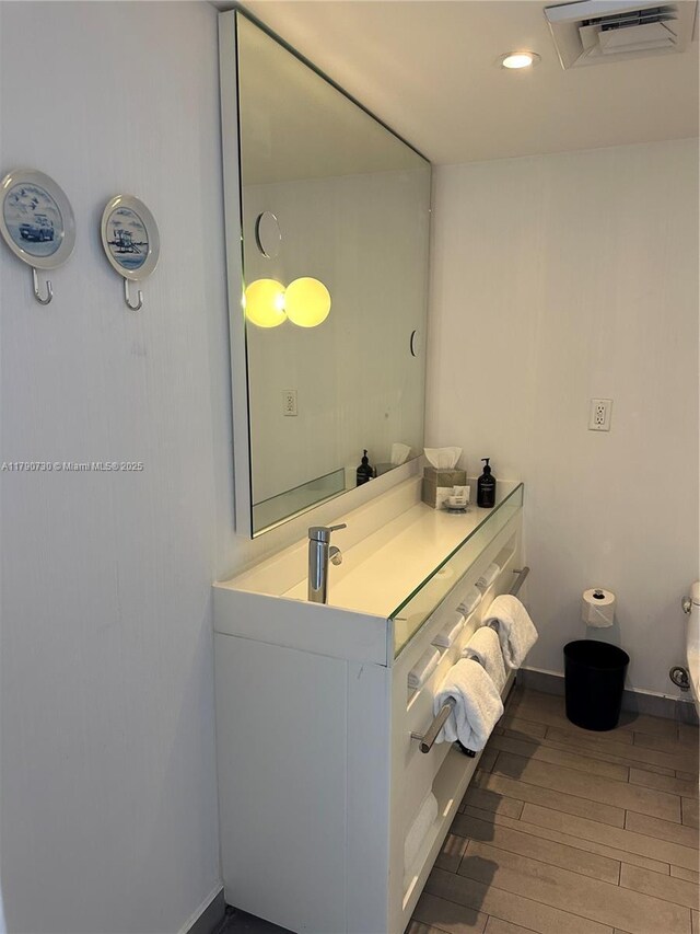 1100 W Ave Unit 1206, Miami Beach, FL 33139 - bathroom with wood finished floors, vanity, and baseboards