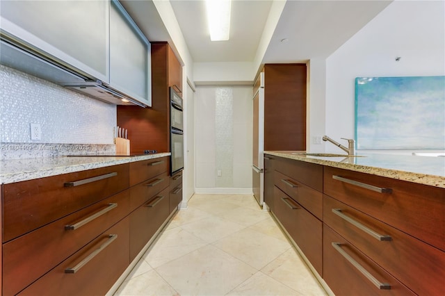 1830 S Ocean Dr Unit 3804, Hallandale Beach, FL 33009 - kitchen with light stone counters, tasteful backsplash, a sink, light tile patterned floors, and modern cabinets