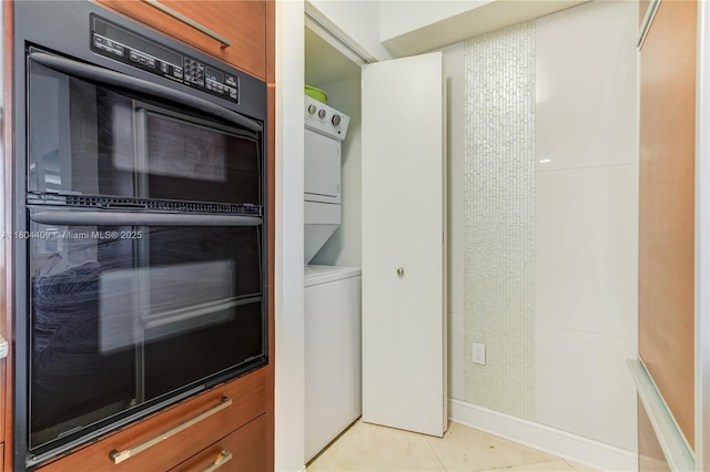 1830 S Ocean Dr Unit 3804, Hallandale Beach, FL 33009 - kitchen featuring stacked washing machine and dryer, light tile patterned floors, and baseboards