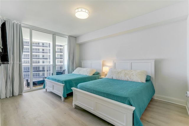 1830 S Ocean Dr Unit 3804, Hallandale Beach, FL 33009 - bedroom featuring light wood-style floors, expansive windows, access to exterior, and baseboards
