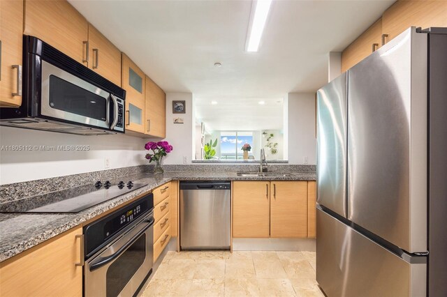 2101 Brickell Ave Unit 807, Miami, FL 33129 - kitchen featuring stainless steel appliances, a sink, glass insert cabinets, and dark stone countertops
