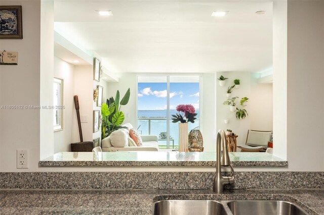 2101 Brickell Ave Unit 807, Miami, FL 33129 - kitchen view of a sink, dark stone counters, and a water view