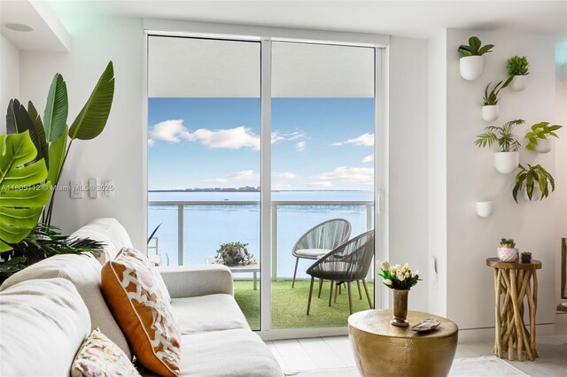 2101 Brickell Ave Unit 807, Miami, FL 33129 - living area featuring plenty of natural light, expansive windows, light tile patterned floors, and a water view
