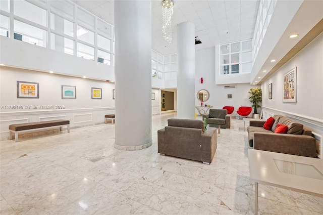 9341 Collins Ave Unit 1204, Surfside, FL 33154 - lobby featuring a high ceiling, a wainscoted wall, a decorative wall, and recessed lighting